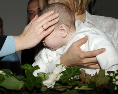 Kind wird nach Taufe gesegnet